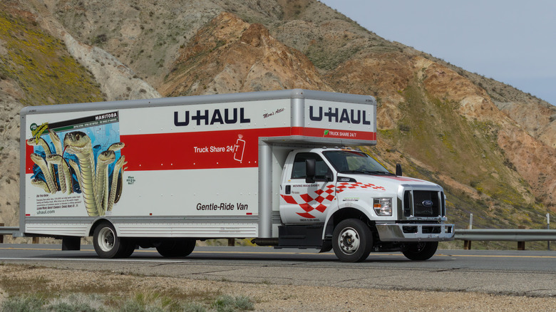 Large U-Haul truck driving through desert