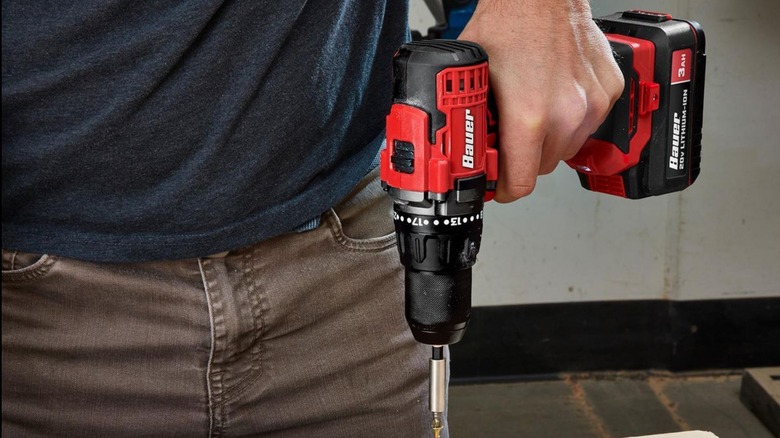 A person using a Bauer 1/2-inch drill/driver to put in a screw