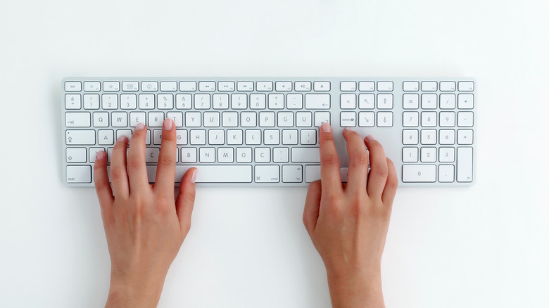 hands on full-sized keyboard