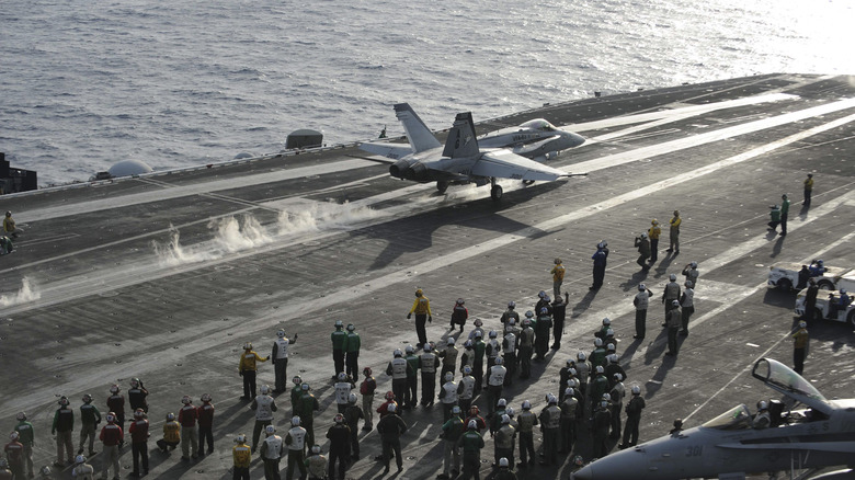 plane landing on aircraft carrier