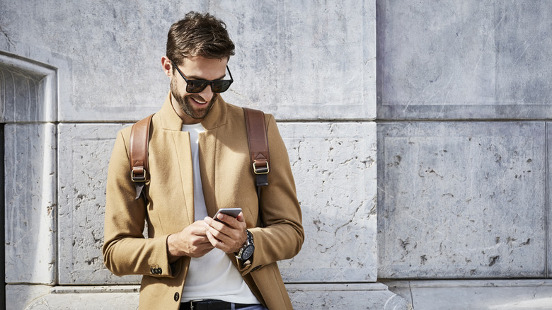 man in sunglasses using phone