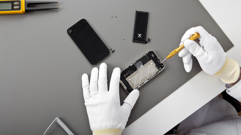 technician fixing smartphone