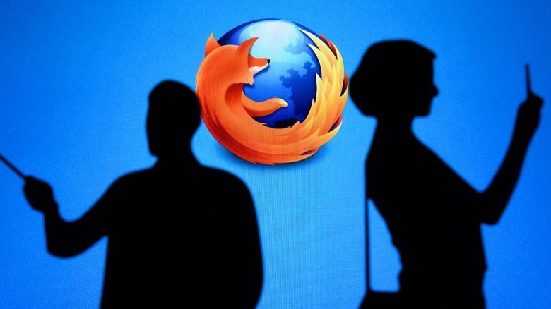 Firefox logo behind people using phones