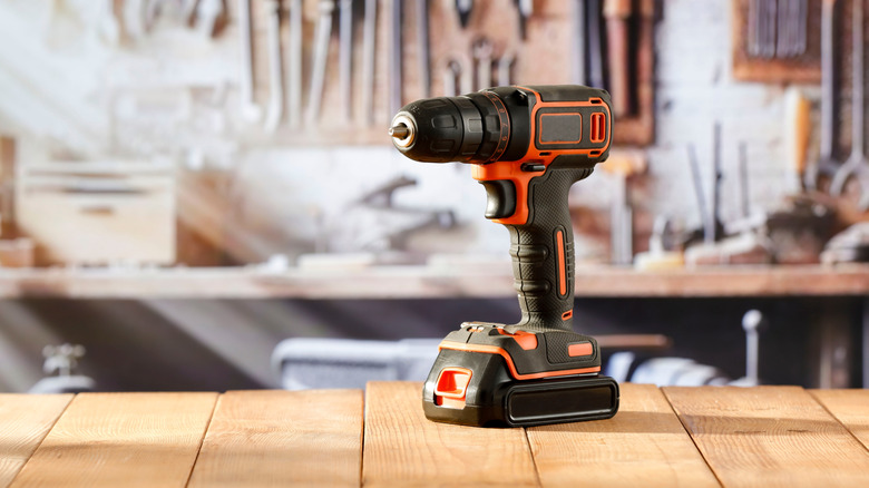 Drill on work bench with tools in background