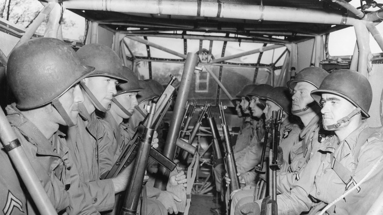 A group of soldiers inside of a glider in WWII.