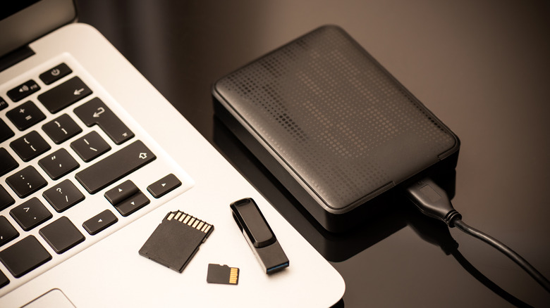 multiple external storage devices next to MacBook