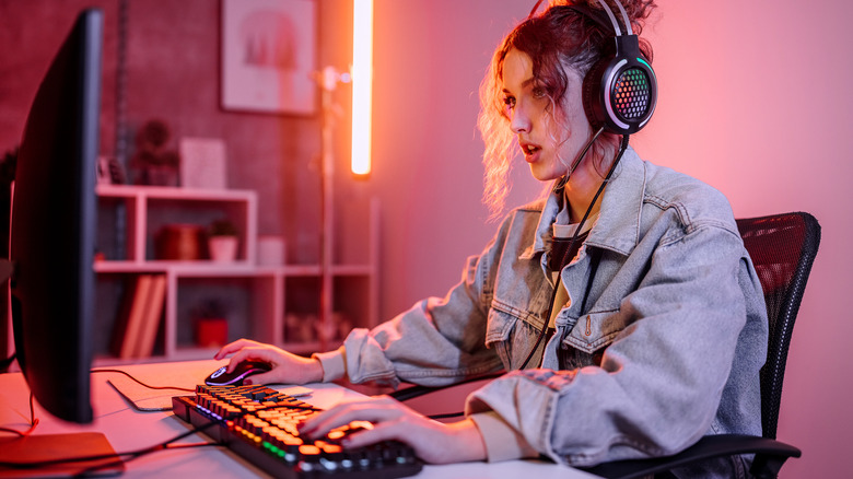 Woman focused on gaming monitor