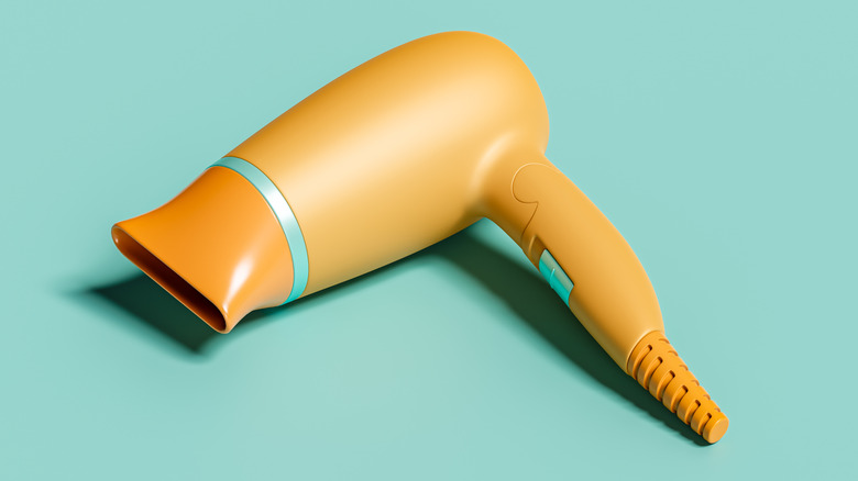 An orange air dryer on a blue surface.