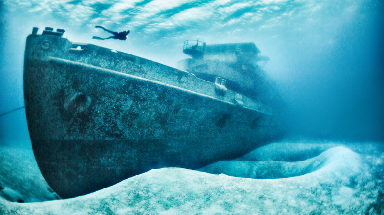 diver among submarine wreckage