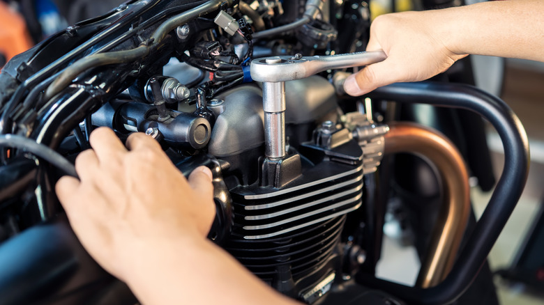 Man repairing bike engine