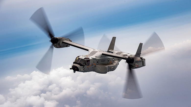 V22 Osprey flying in the air with clouds