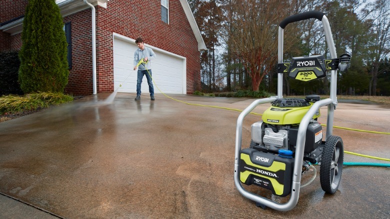 Person using Ryobi pressure washer