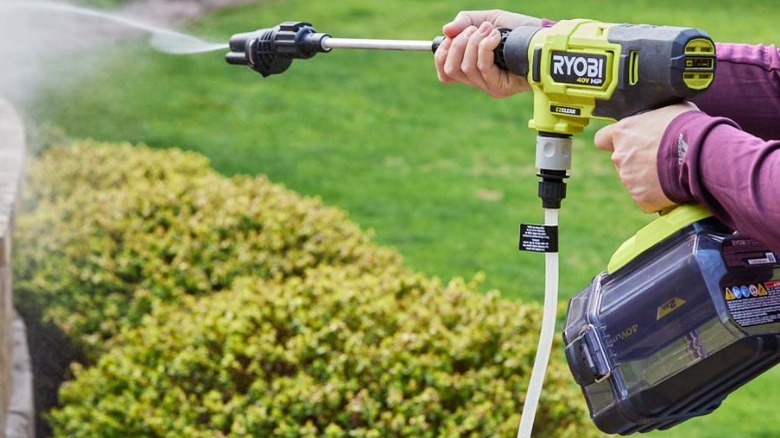 Person using Ryobi pressure washer