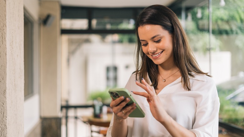 Woman scrolling on iPhone