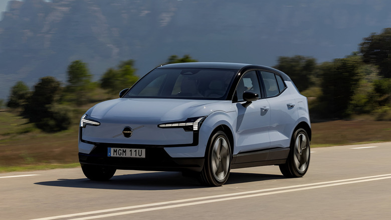 The Volvo EX30 electric SUV being driven on a road.