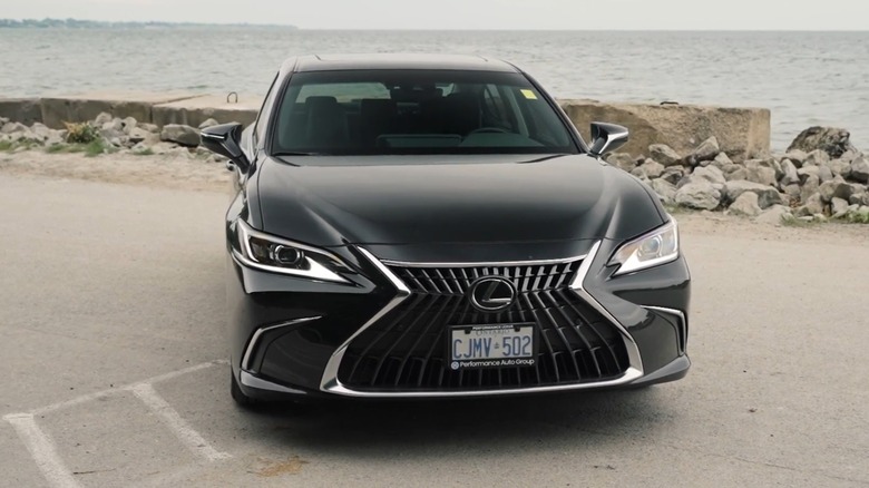 A black 2023 Lexus ES 350 parked outside near water