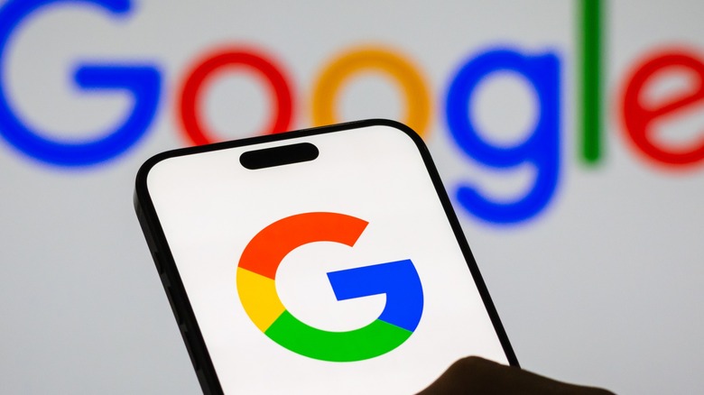 Google Logo on display on both smartphone and background