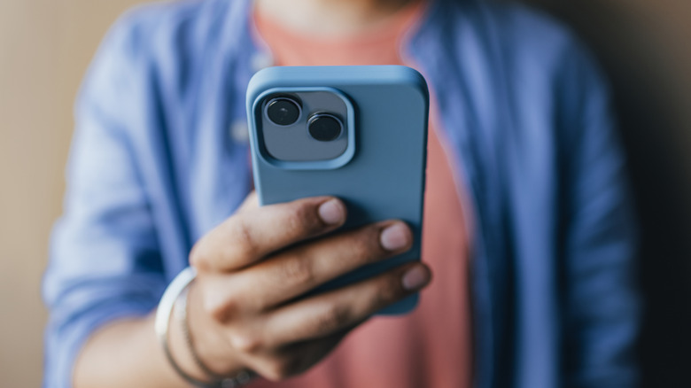 iPhone X blue cover in hand