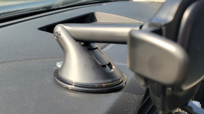 Close up of how a phone holder is mounted to a dashboard