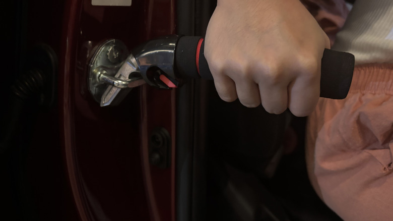 woman using portable car door handle