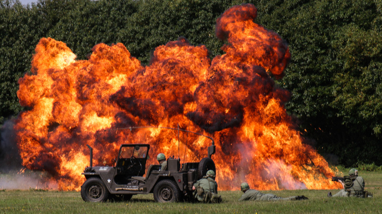 Soldiers next to a napalm attack 