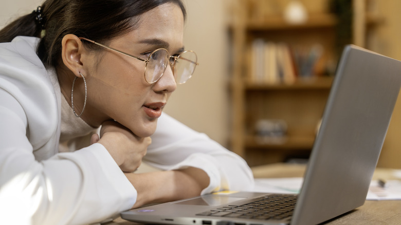 Woman looking at laptop screen