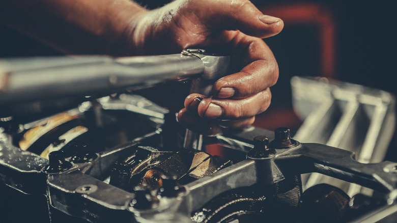 Person repairing vehicle component