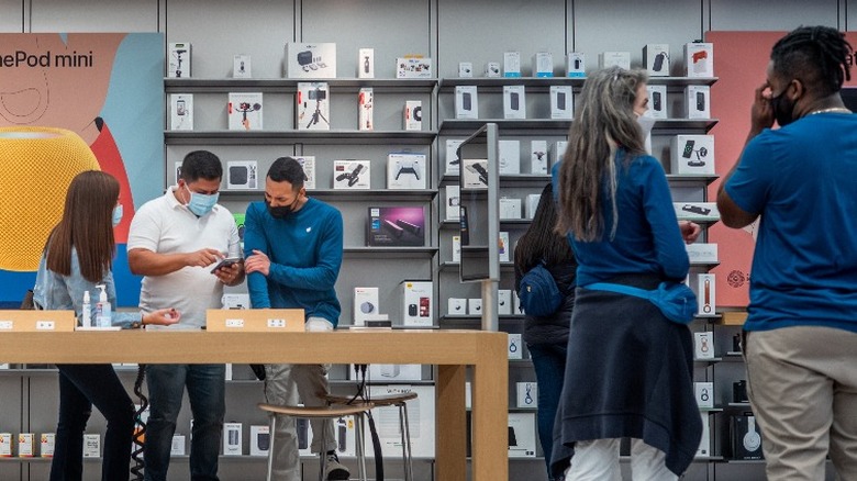 Employees and customers at an Apple Store