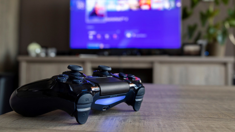 PS4 controller with blue lightbar on table