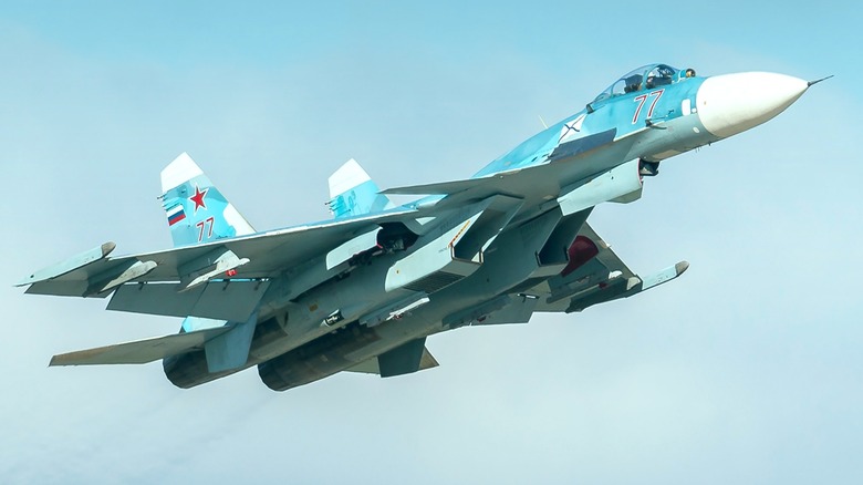 A Russian Sukhoi Su-33 flying before a cloudy sky