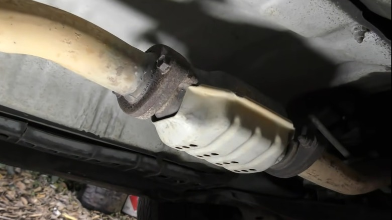 An image of a car's catalytic converter while connected to the exhaust system