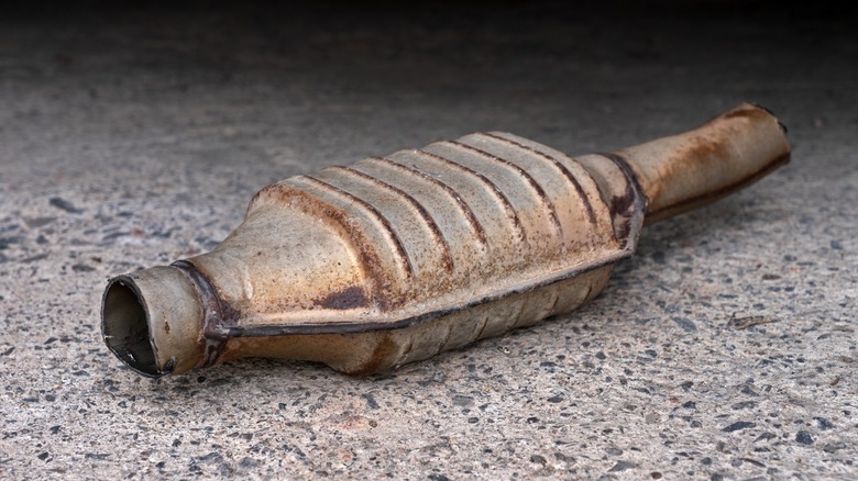 An old catalytic converter sitting on the ground