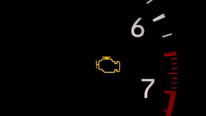 A check engine light illuminated on a vehicle dashboard