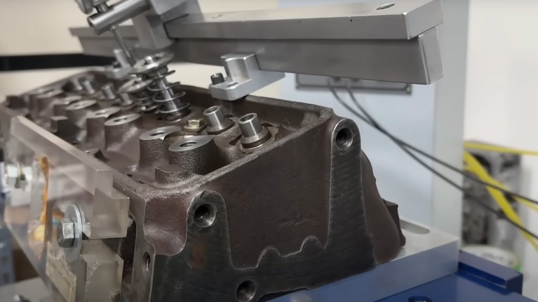 A double hump small block Chevy cylinder head mounted to a flow-bench