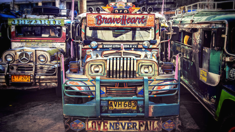 Brightly painted jeepneys are parked in a bus station lot in Baguio City, the Philippines