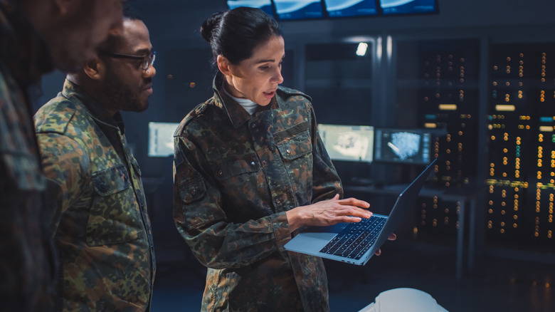 military personnel with a laptop in a meeting