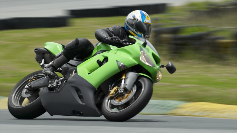 Green motorcycle racing on track