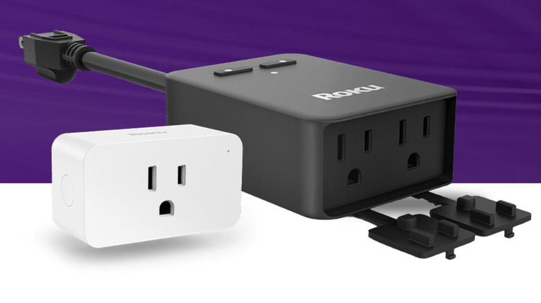 Roku smart indoor and outdoor plugs side by side on a white table with a purple background