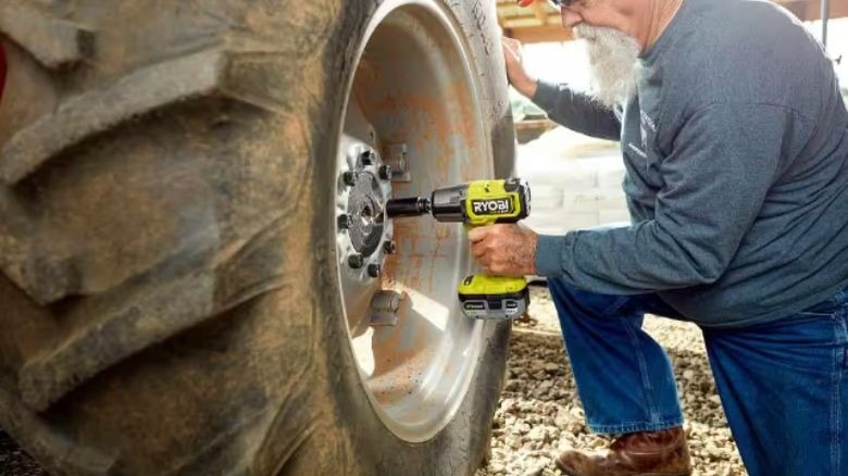 Ryobi Brushless Impact Wrench unbolting tire.