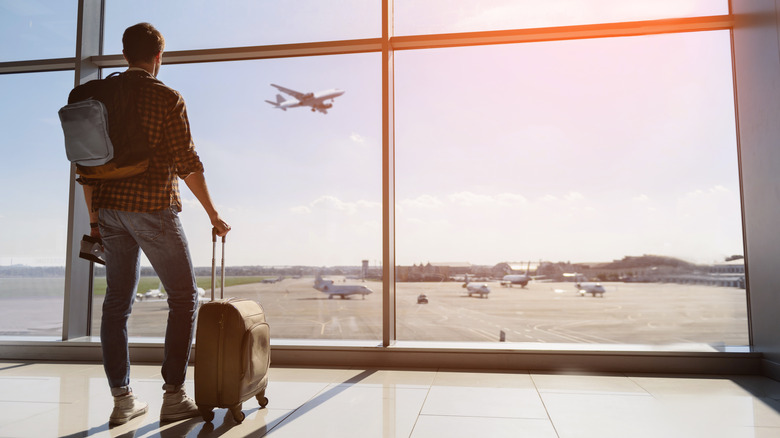 man with luggage at airport