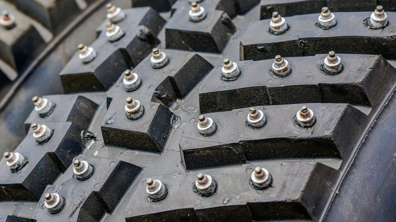 A closeup of a studded tire