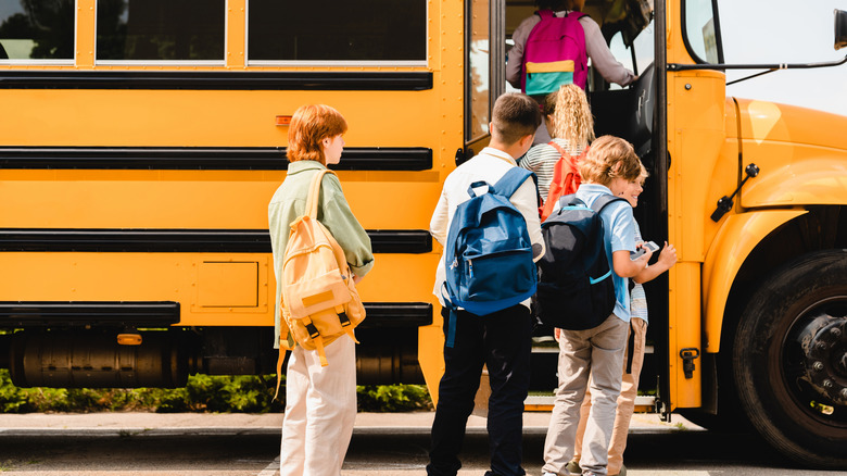 Kids getting on school bus