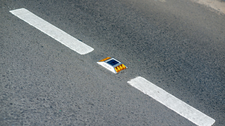 Cat's eye reflector on road surface