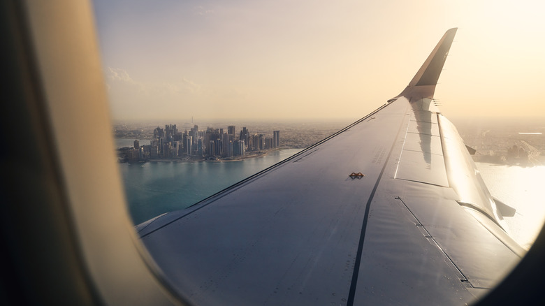 View of wing and city from airplane window