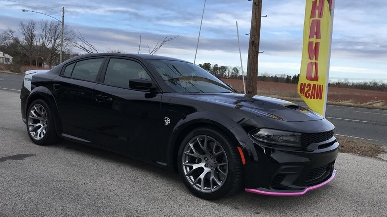 A Dodge Charger with pink splitter guards at the front.