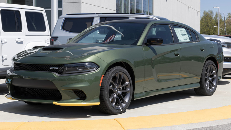 A green Dodge Charger with yellow splitter guards at the front.