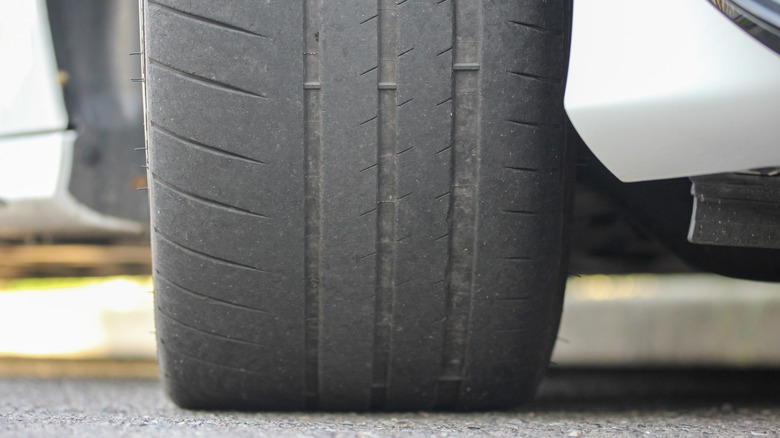 Tire on road showing the three tire wear bars