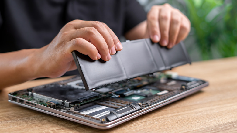 Technician Man holding the new battery