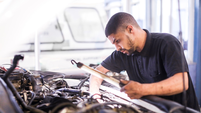 Technician fixing a diesel engine