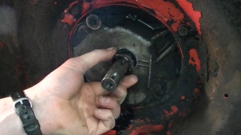 person removing crank seal